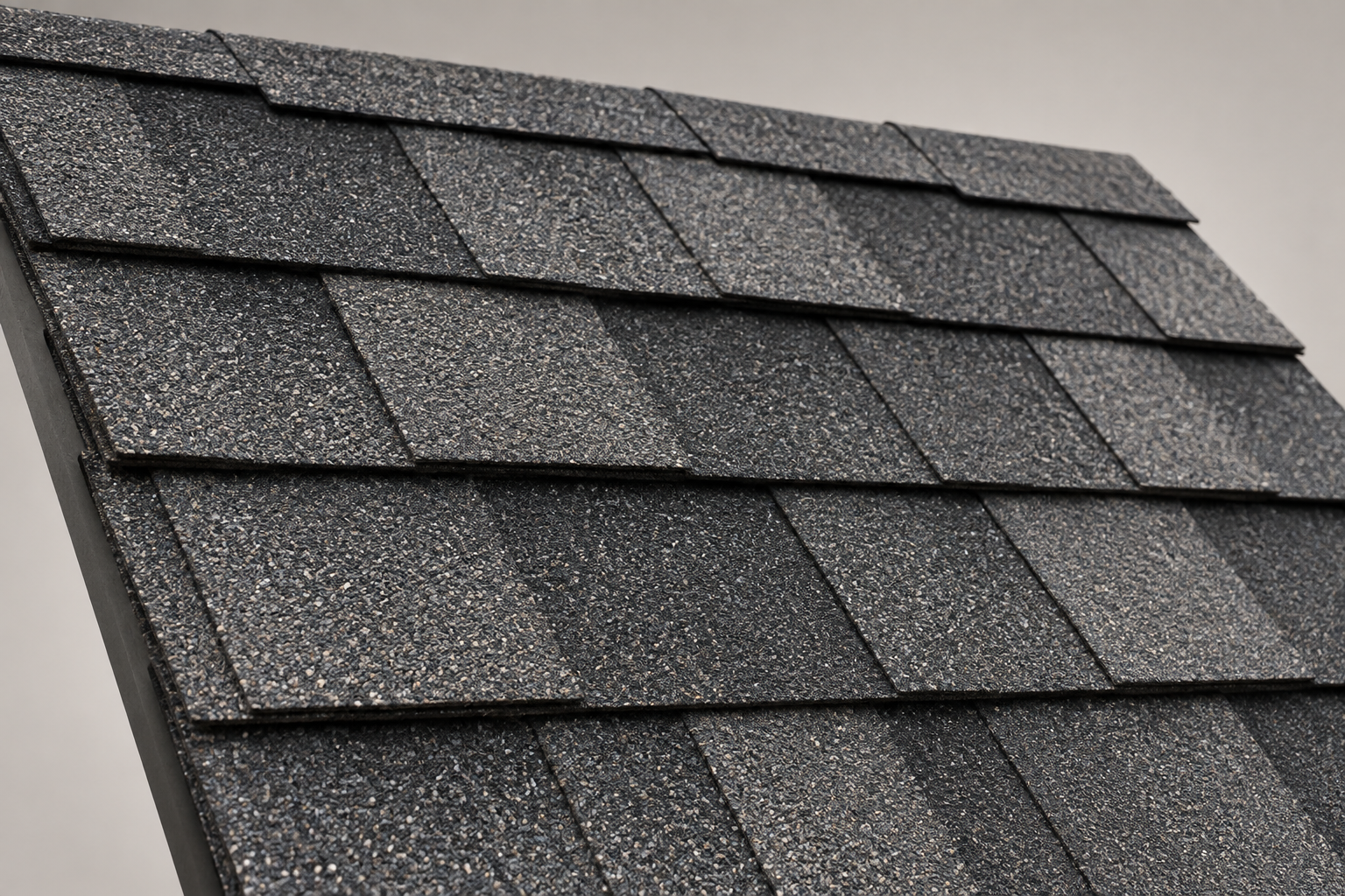 Realistic rendering of overlapping charcoal architectural asphalt shingles